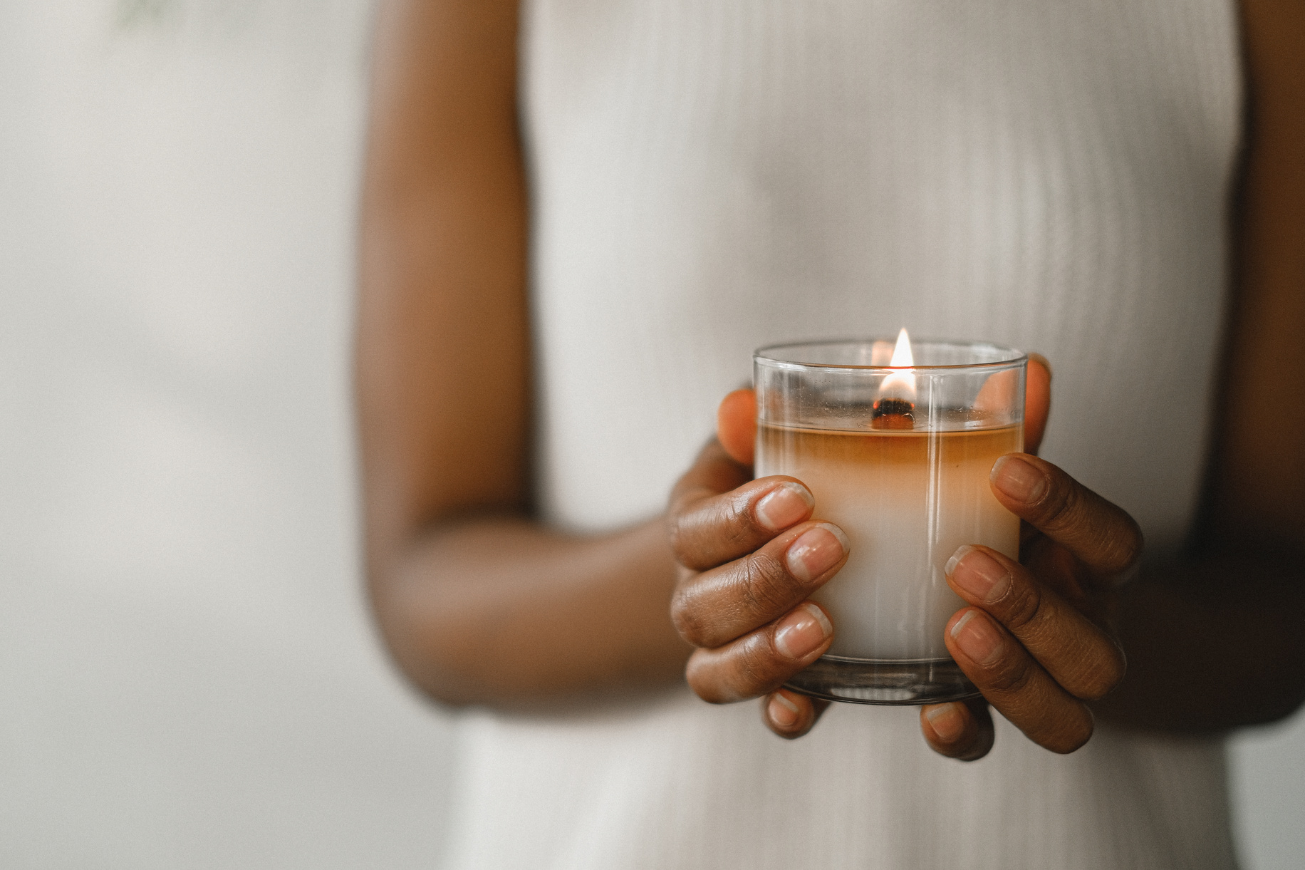 Crop black woman with burning candle